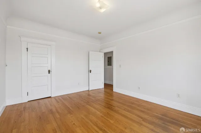 a view of an empty room and wooden floor