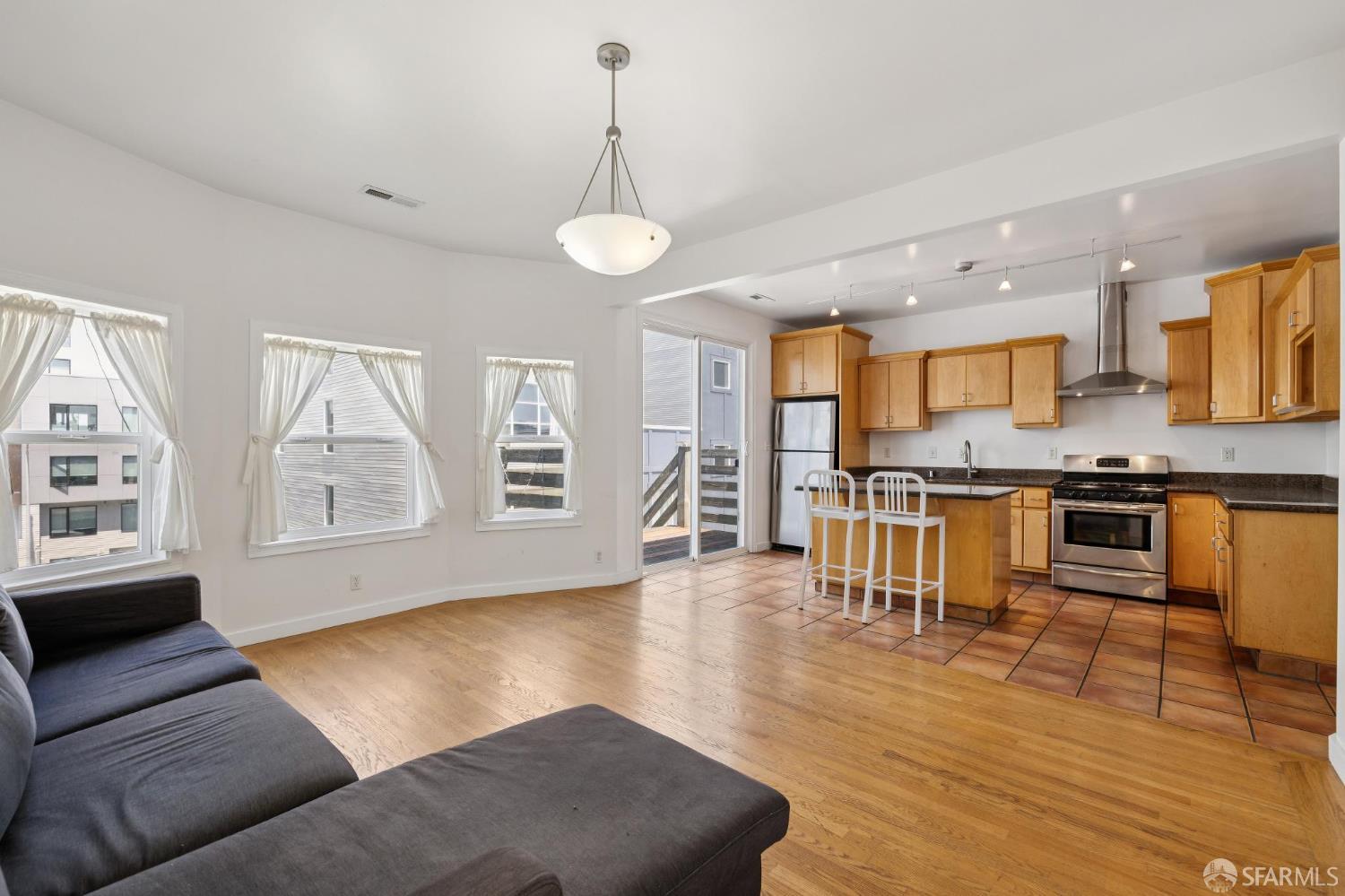 984 Harrison Street San Francisco, CA 94107 - Photo 8 of 34 a living room with stainless steel appliances furniture wooden floor and a kitchen