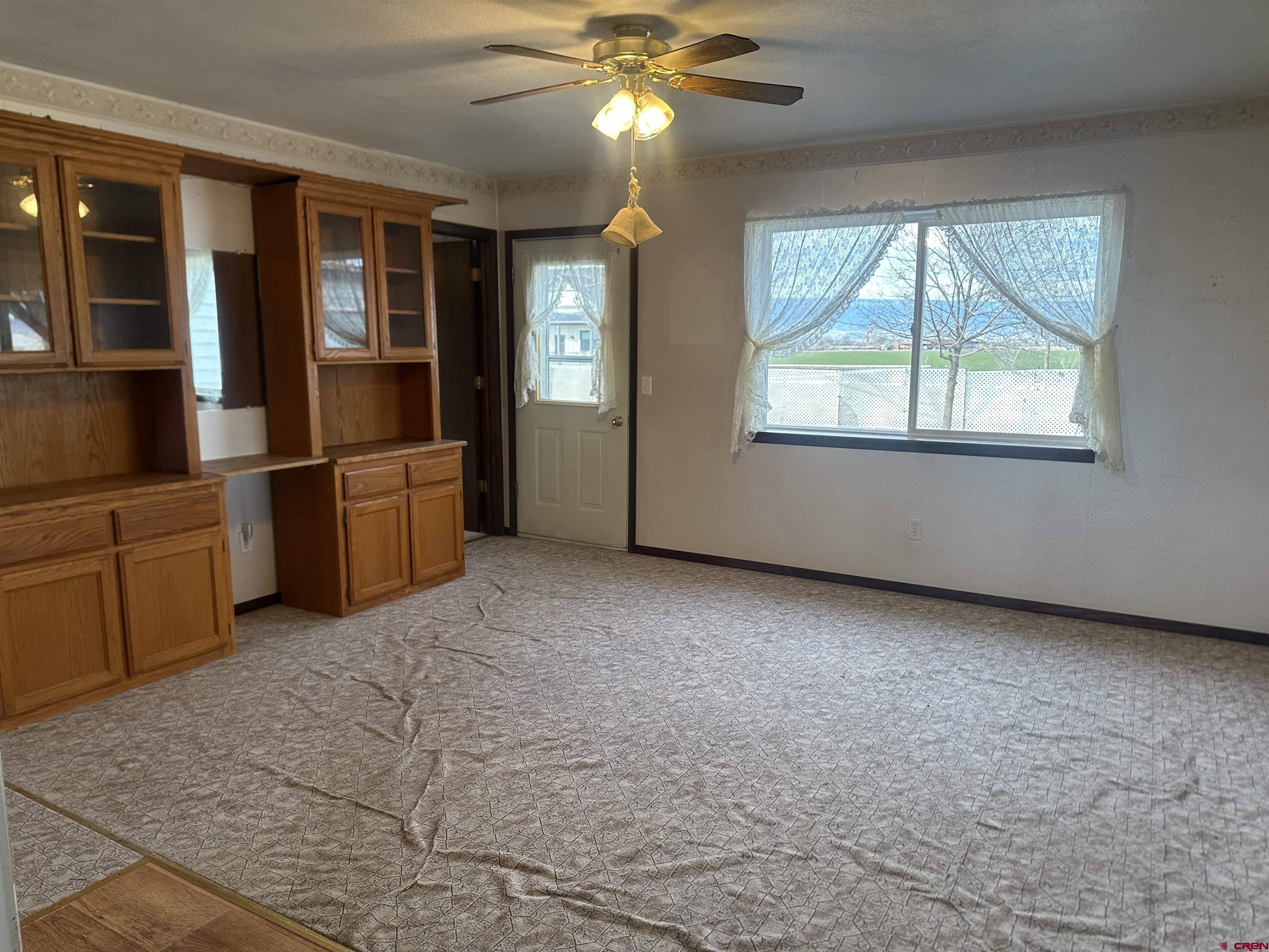 57001 Begonia Road Olathe, CO 81425 - Photo 11 of 37 an empty room with windows and chandelier fan