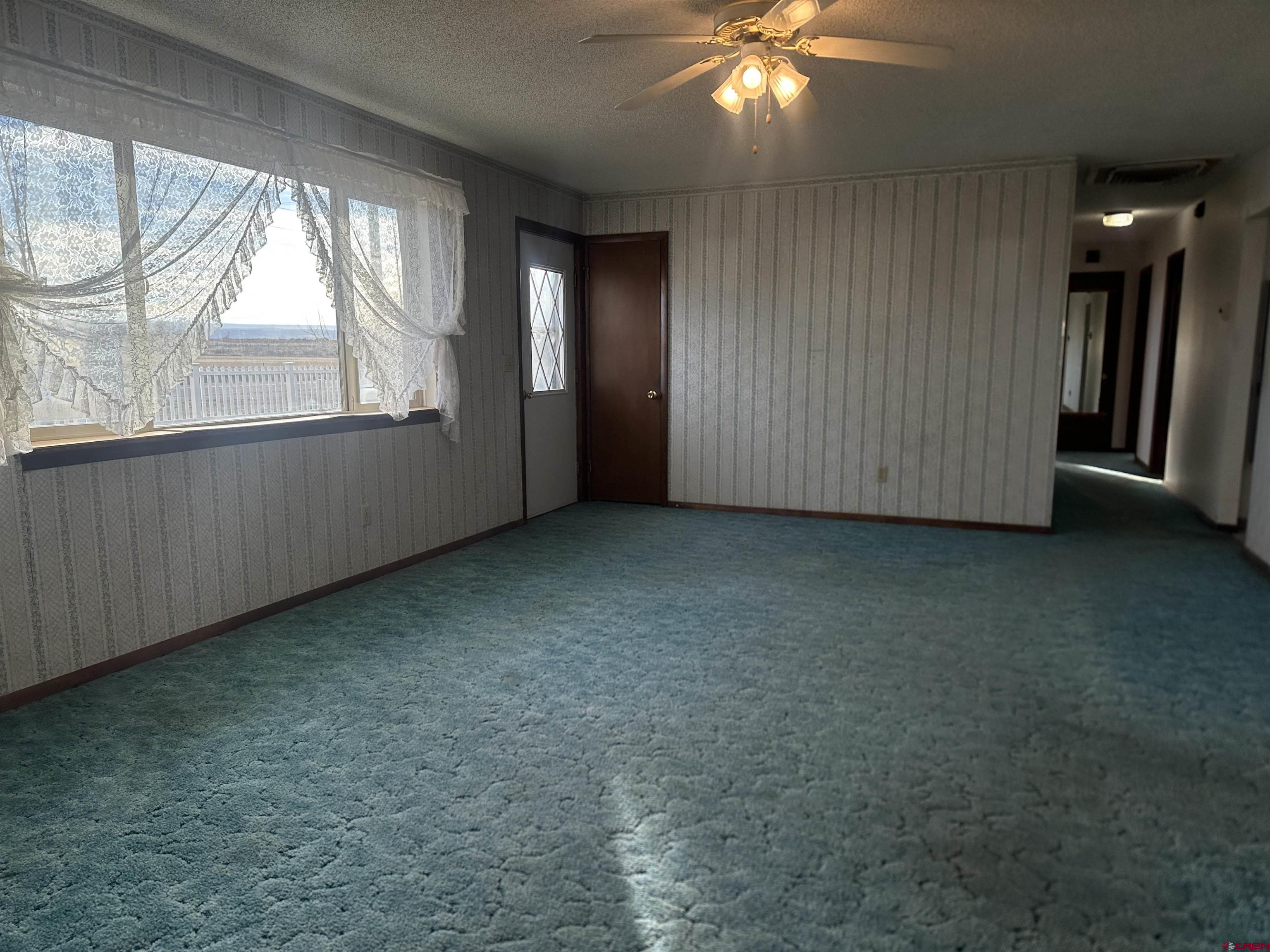 57001 Begonia Road Olathe, CO 81425 - Photo 14 of 37 an empty room with a empty space and windows