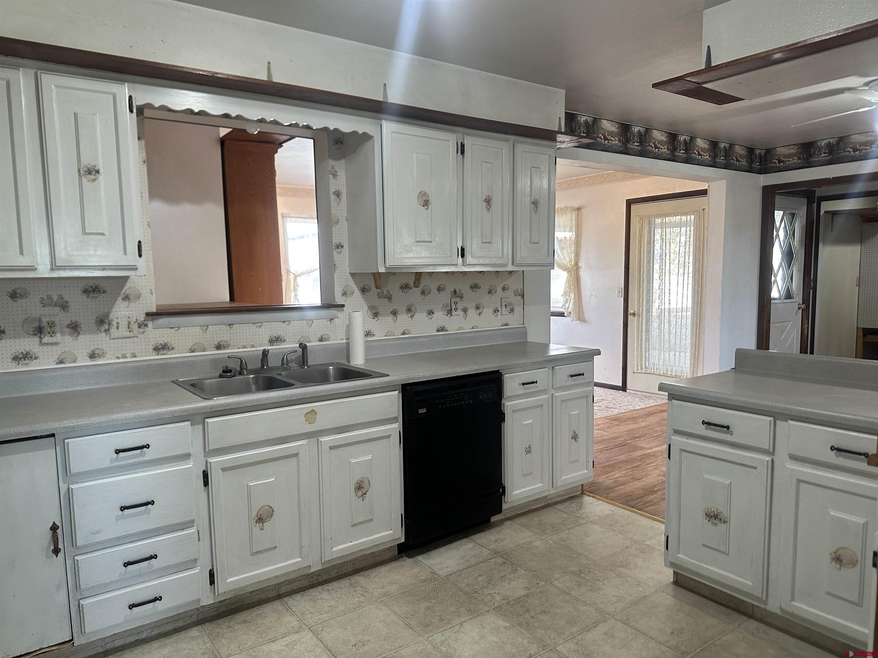 57001 Begonia Road Olathe, CO 81425 - Photo 22 of 37 a kitchen with cabinets appliances and a window