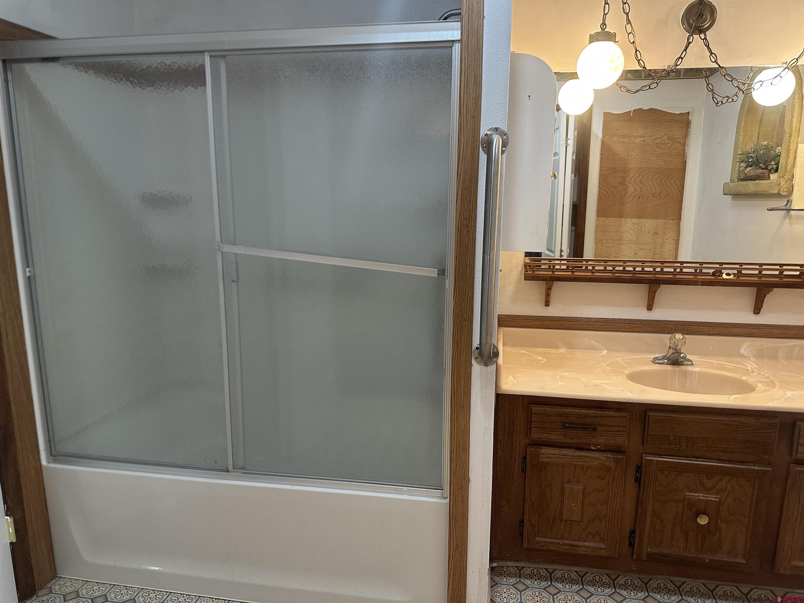 57001 Begonia Road Olathe, CO 81425 - Photo 23 of 37 a bathroom with a granite countertop sink and a mirror