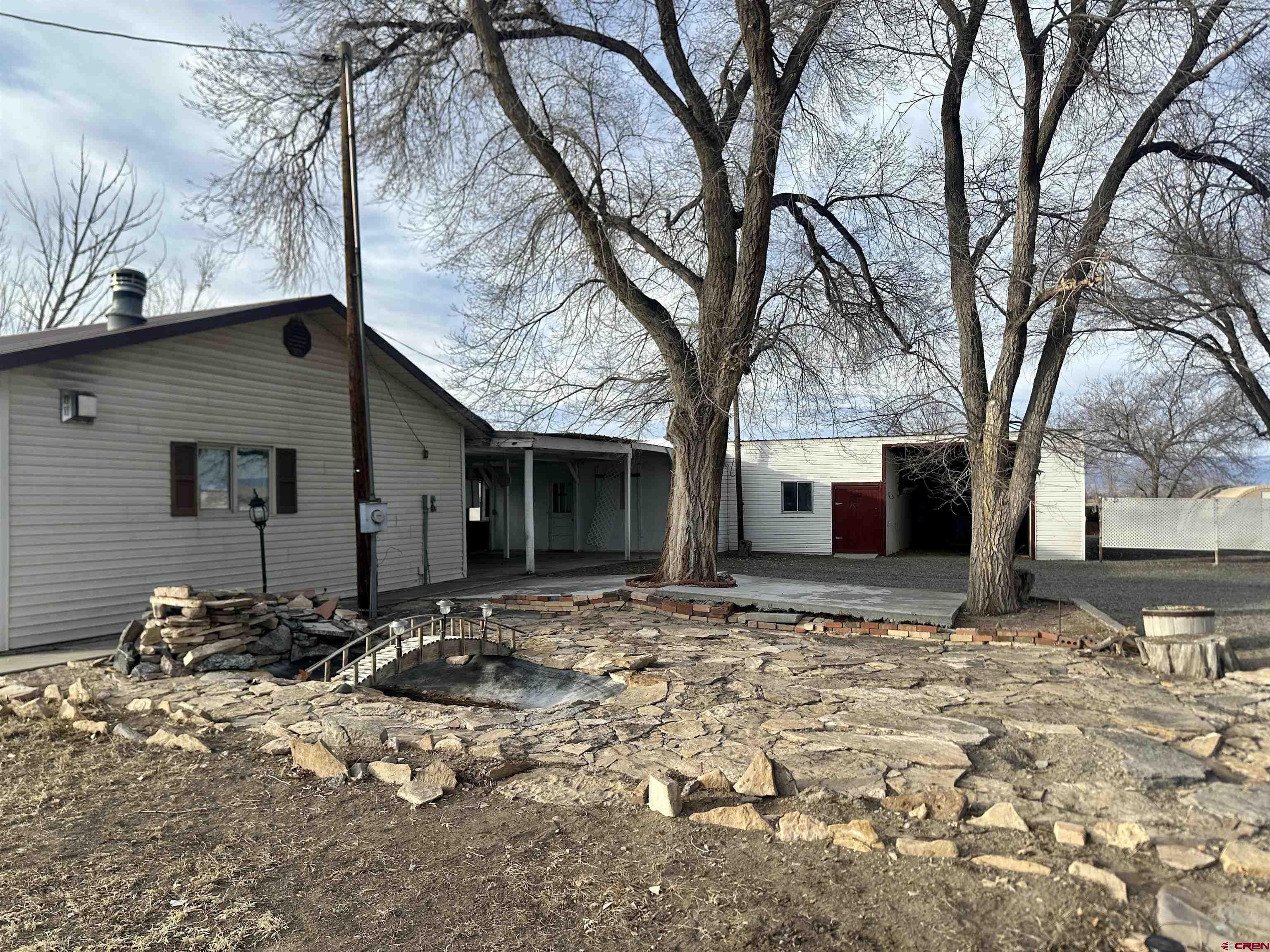 57001 Begonia Road Olathe, CO 81425 - Photo 30 of 37 a tree in front of a white house