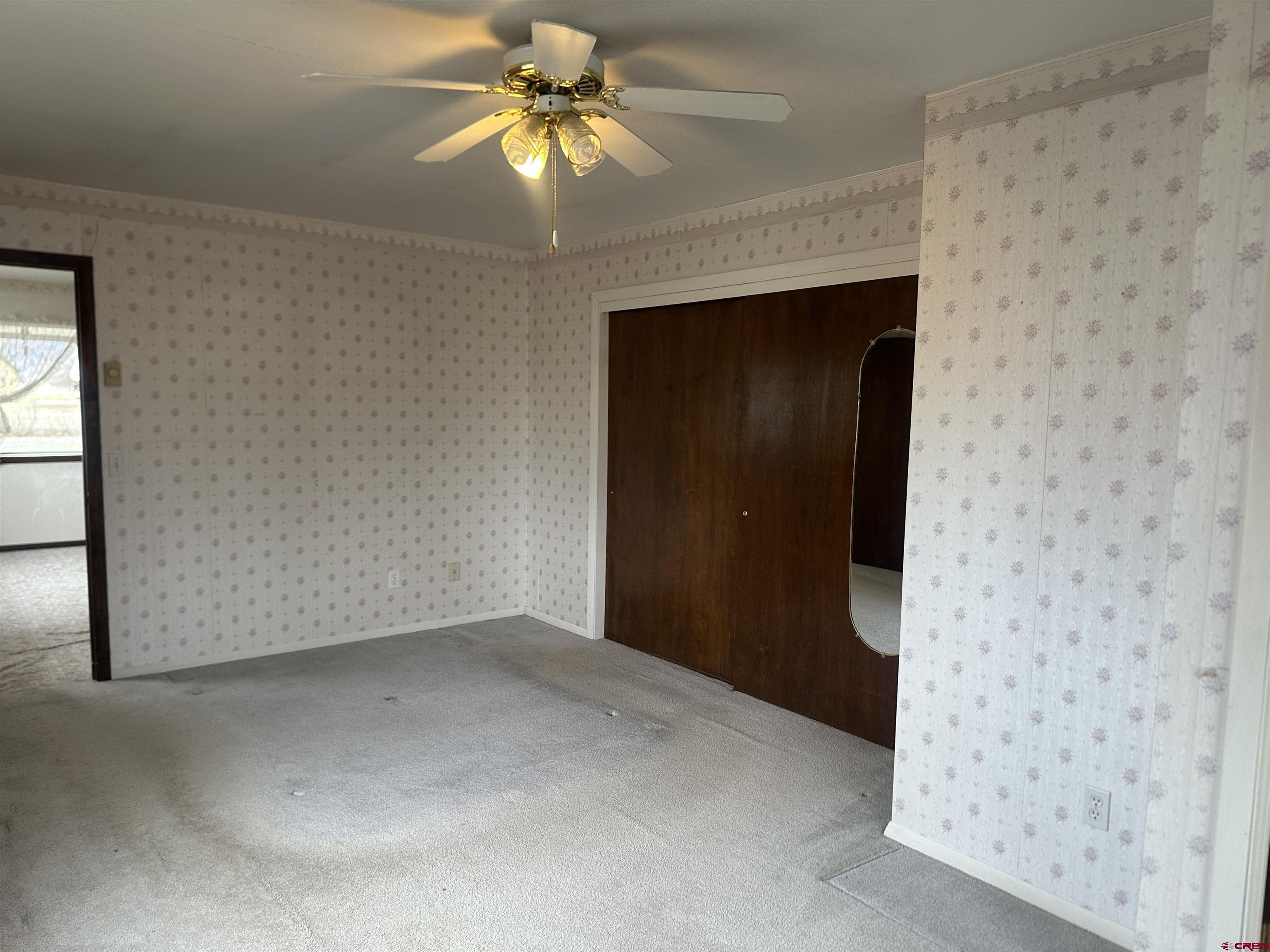 57001 Begonia Road Olathe, CO 81425 - Photo 32 of 37 an empty room with a ceiling fan and a window