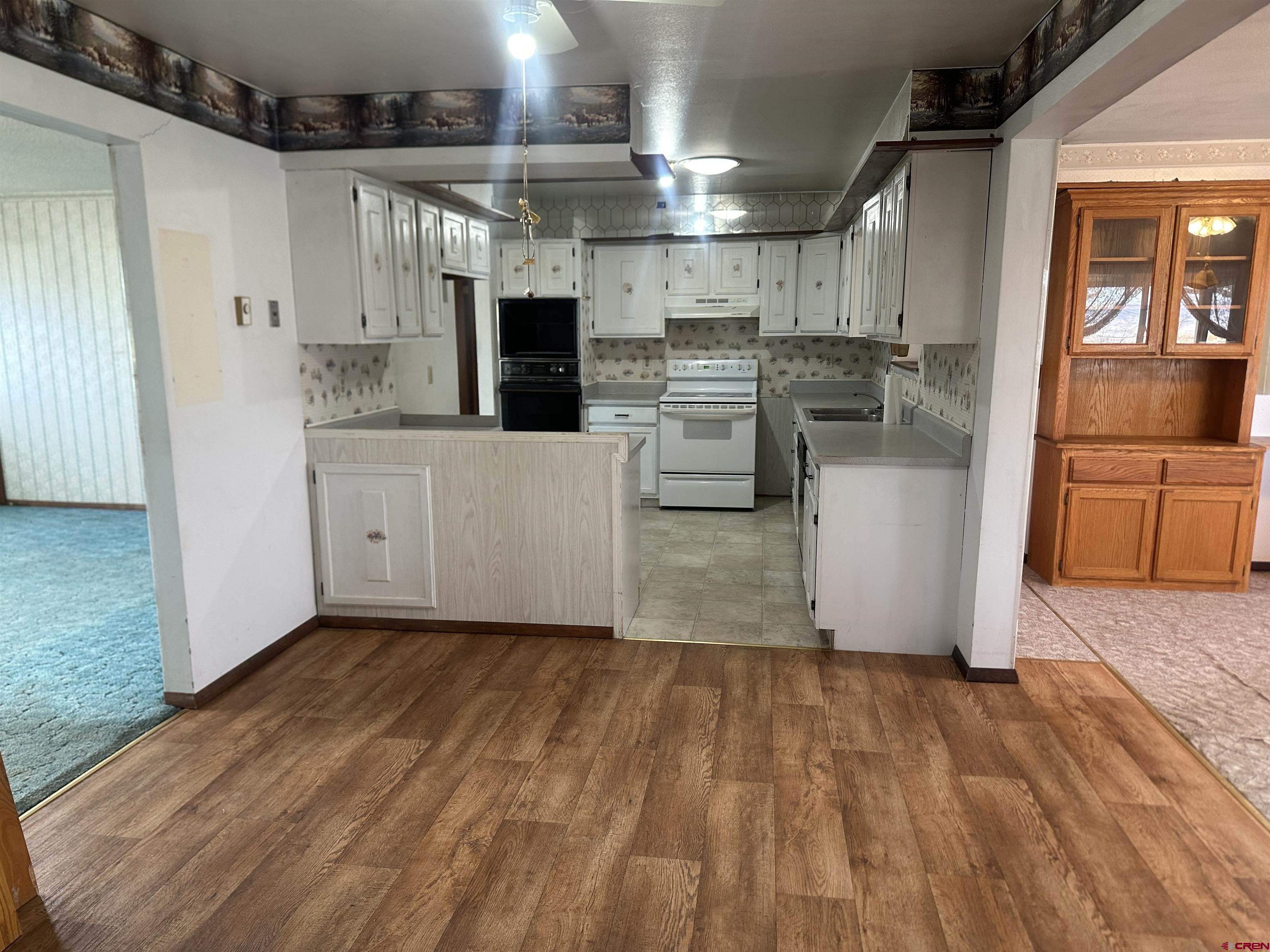 57001 Begonia Road Olathe, CO 81425 - Photo 9 of 37 a kitchen with cabinets and wooden floor