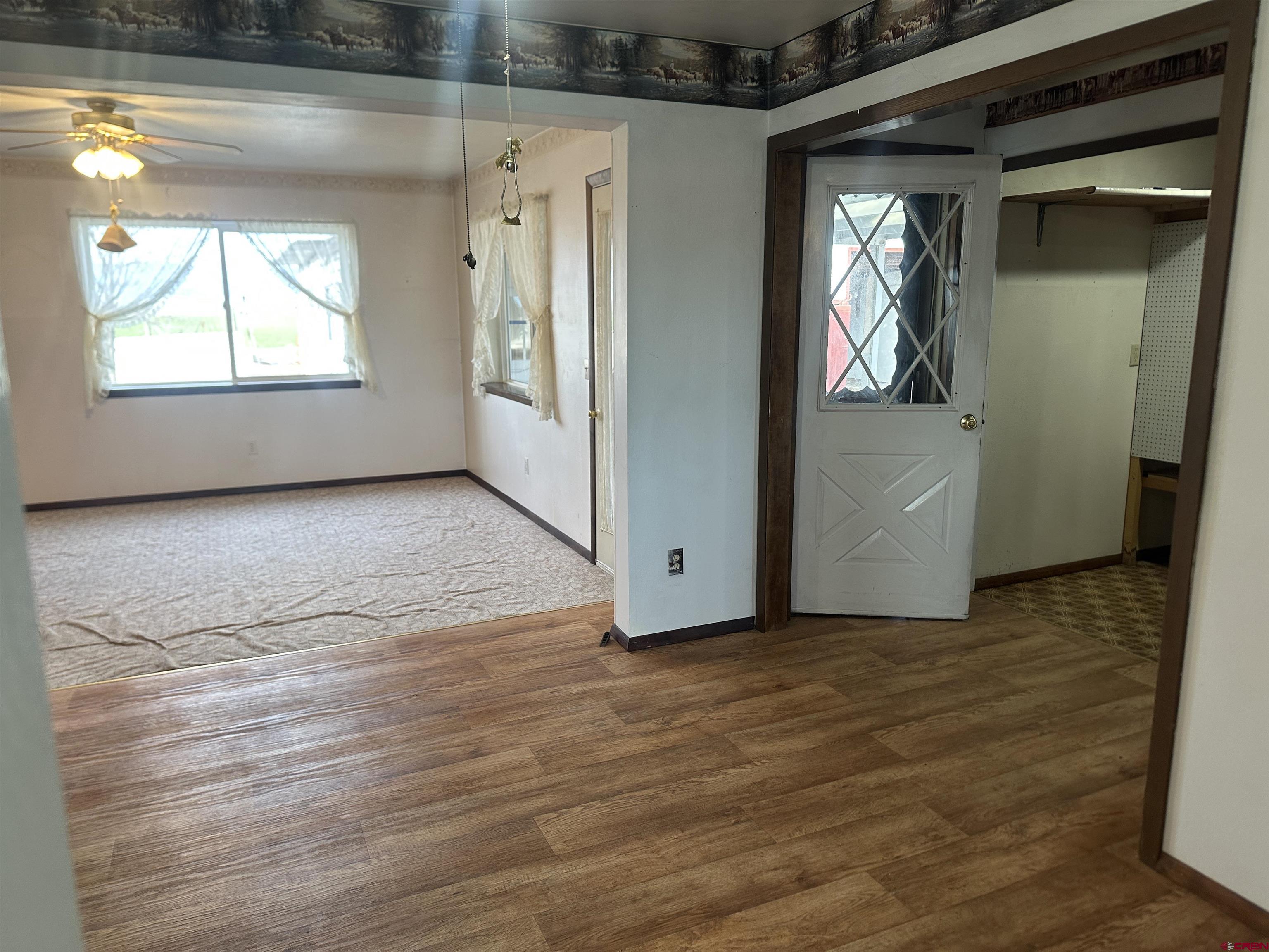 57001 Begonia Road Olathe, CO 81425 - Photo 10 of 37 a view of an empty room with wooden floor and a window