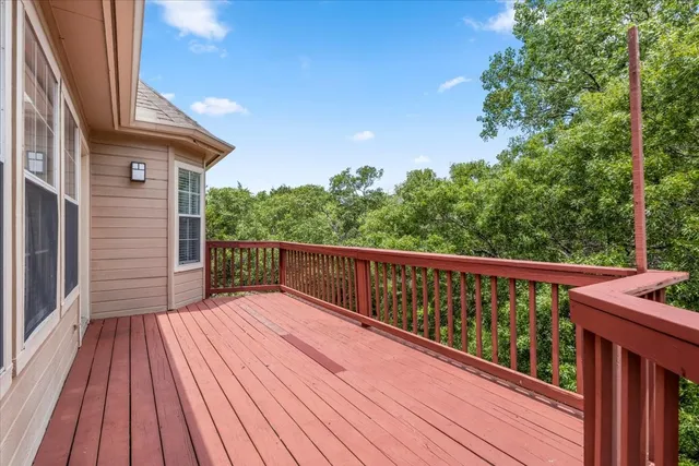 a balcony with wooden floor and fence
