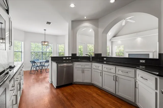 a large white kitchen with lots of counter space and a sink