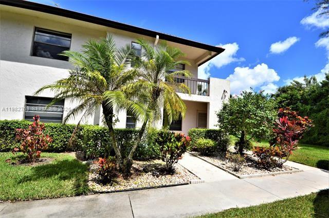 7944 Eastlake Drive, Unit D Boca Raton, FL 33433 - Photo 2 of 29 a front view of a house having yard