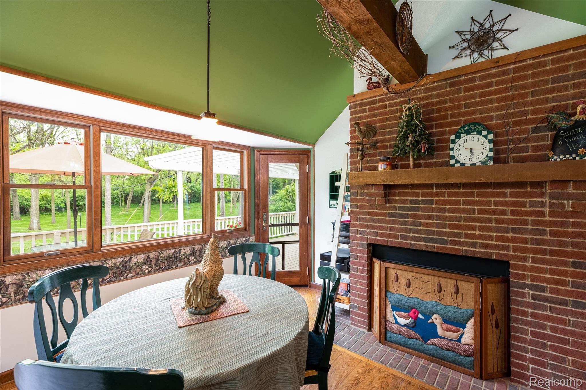 7751 Ridge Road Canton, MI 48187 - Photo 19 of 48 Breakfast Area with Gas Fireplace and French Doors to Rear Deck