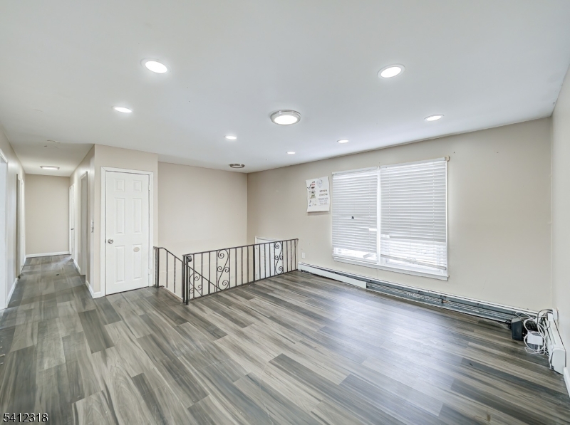 42 Mercer Street Carteret, NJ 07008 - Photo 14 of 35 a view of an empty room with wooden floor and windows