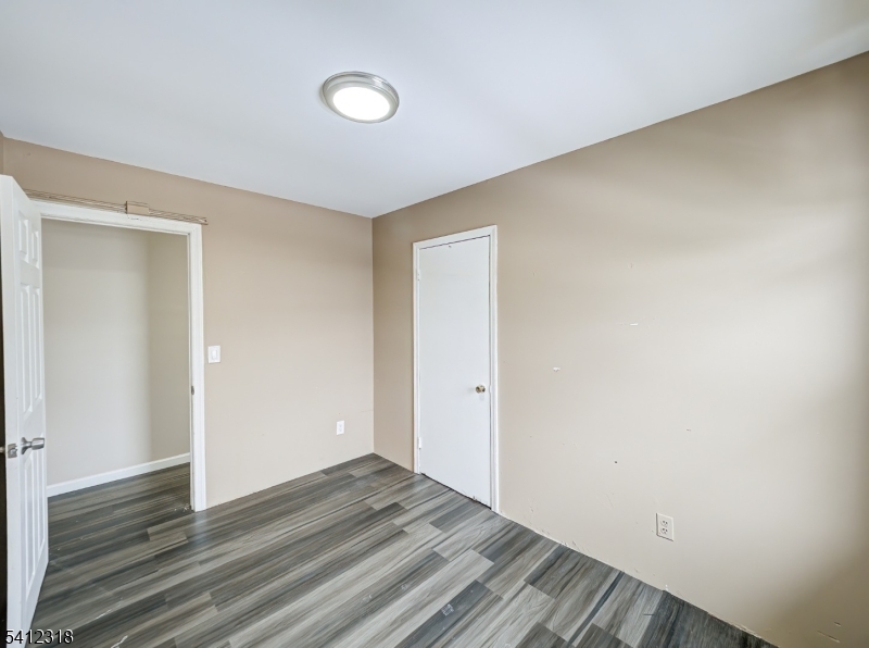 42 Mercer Street Carteret, NJ 07008 - Photo 22 of 35 a view of an empty room and wooden floor