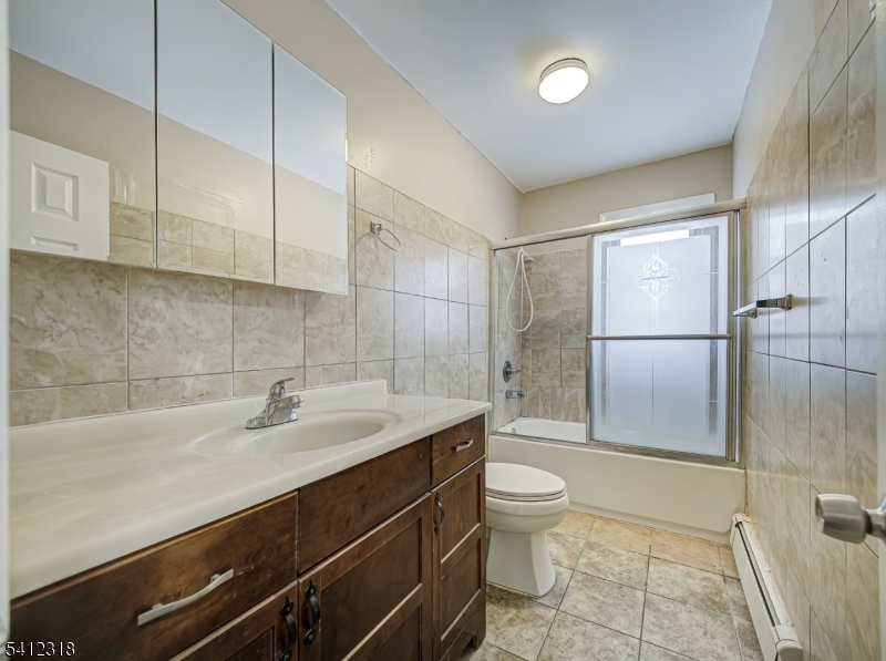 42 Mercer Street Carteret, NJ 07008 - Photo 24 of 35 a bathroom with a sink a toilet and shower