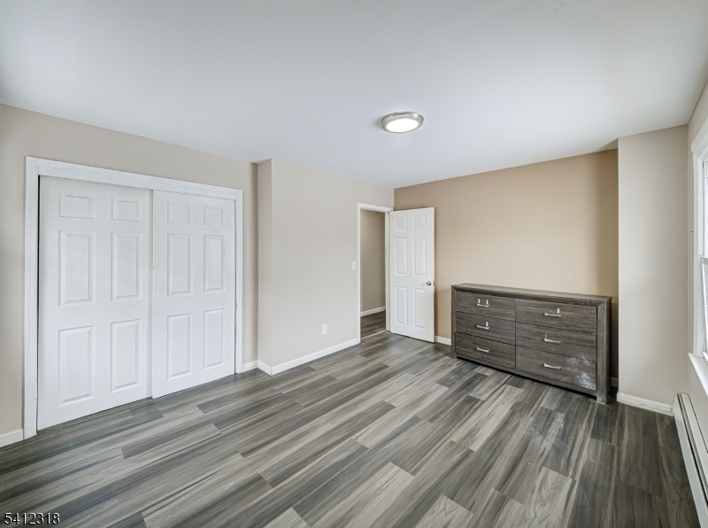 42 Mercer Street Carteret, NJ 07008 - Photo 25 of 35 an empty room with wooden floor and closet
