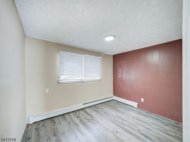 42 Mercer Street Carteret, NJ 07008 - Photo 28 of 35 an empty room with wooden floor and windows