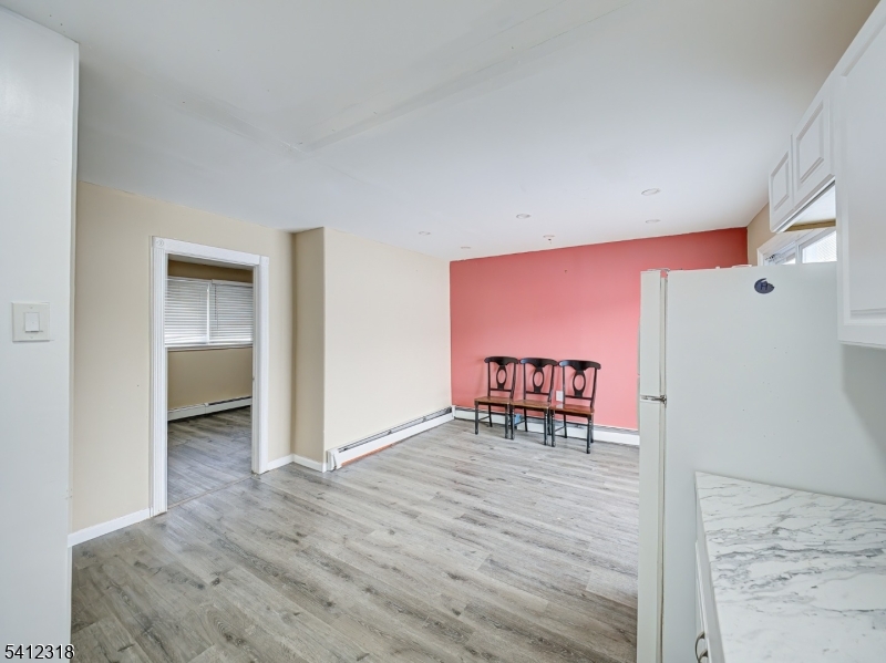 42 Mercer Street Carteret, NJ 07008 - Photo 32 of 35 a view of a hallway with wooden floor and a bathroom