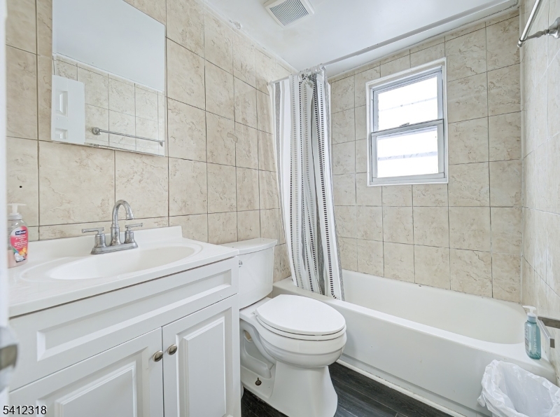 42 Mercer Street Carteret, NJ 07008 - Photo 33 of 35 a bathroom with a sink a toilet and a bathtub