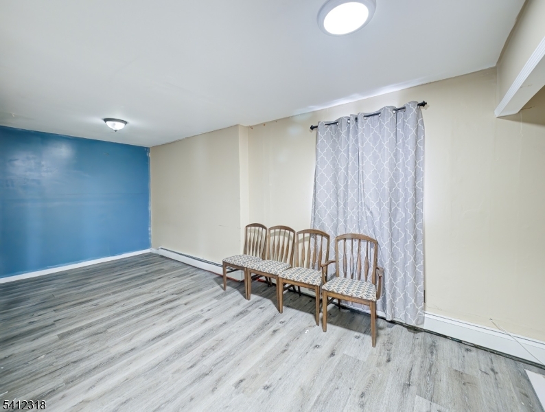 42 Mercer Street Carteret, NJ 07008 - Photo 34 of 35 an empty room with wooden floor and windows