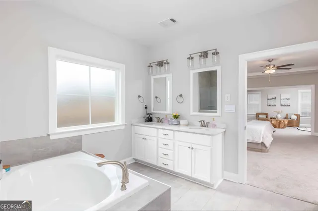 a bathroom with a granite countertop sink mirror and