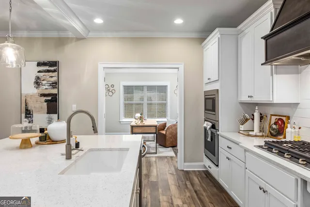 a kitchen with sink refrigerator and stove