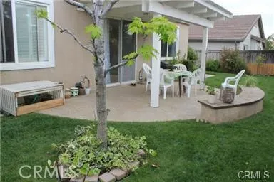 a view of a patio with table and chairs and potted plants