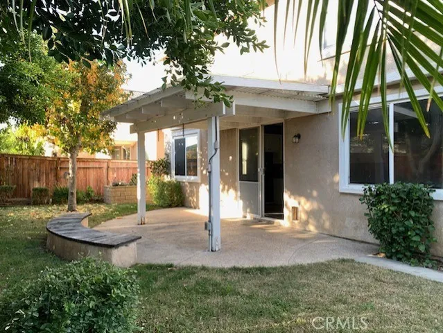 a view of a backyard with table and chairs and a small yard