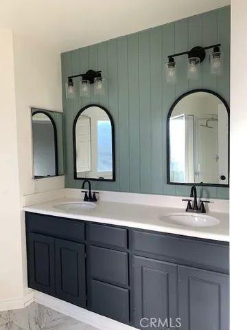 a bathroom with a double vanity sink and a mirror