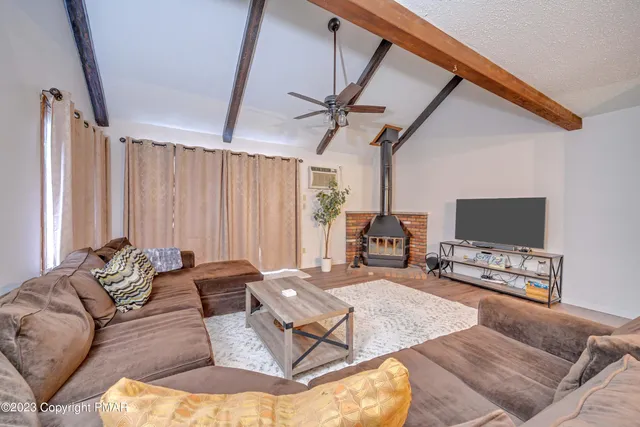 a living room with furniture and a flat screen tv