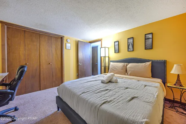 a bedroom with a bed a desk and chair