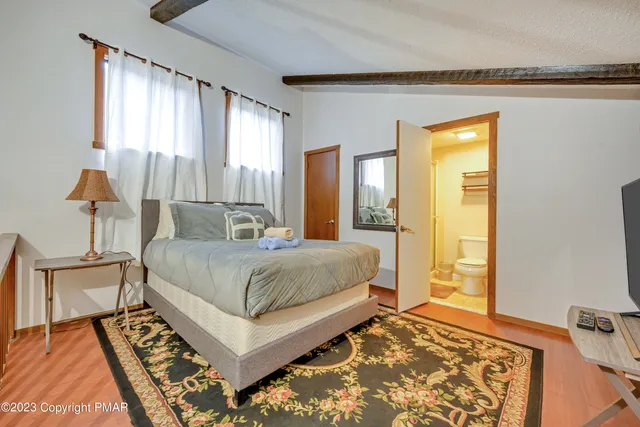 a bedroom with a bed and a lamp on table