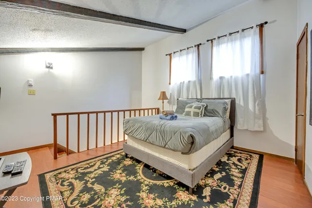 a bedroom with a bed and a rug