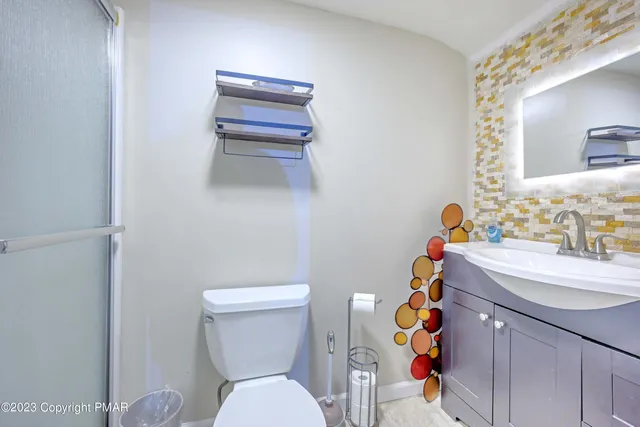 a bathroom with a sink toilet and mirror
