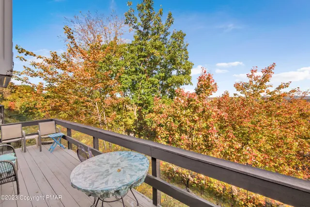 a view of balcony with wooden floor and fence