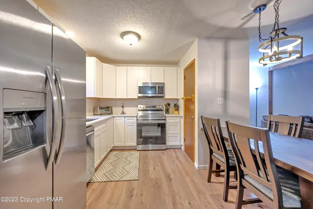 a kitchen with refrigerator cabinets and a counter top space
