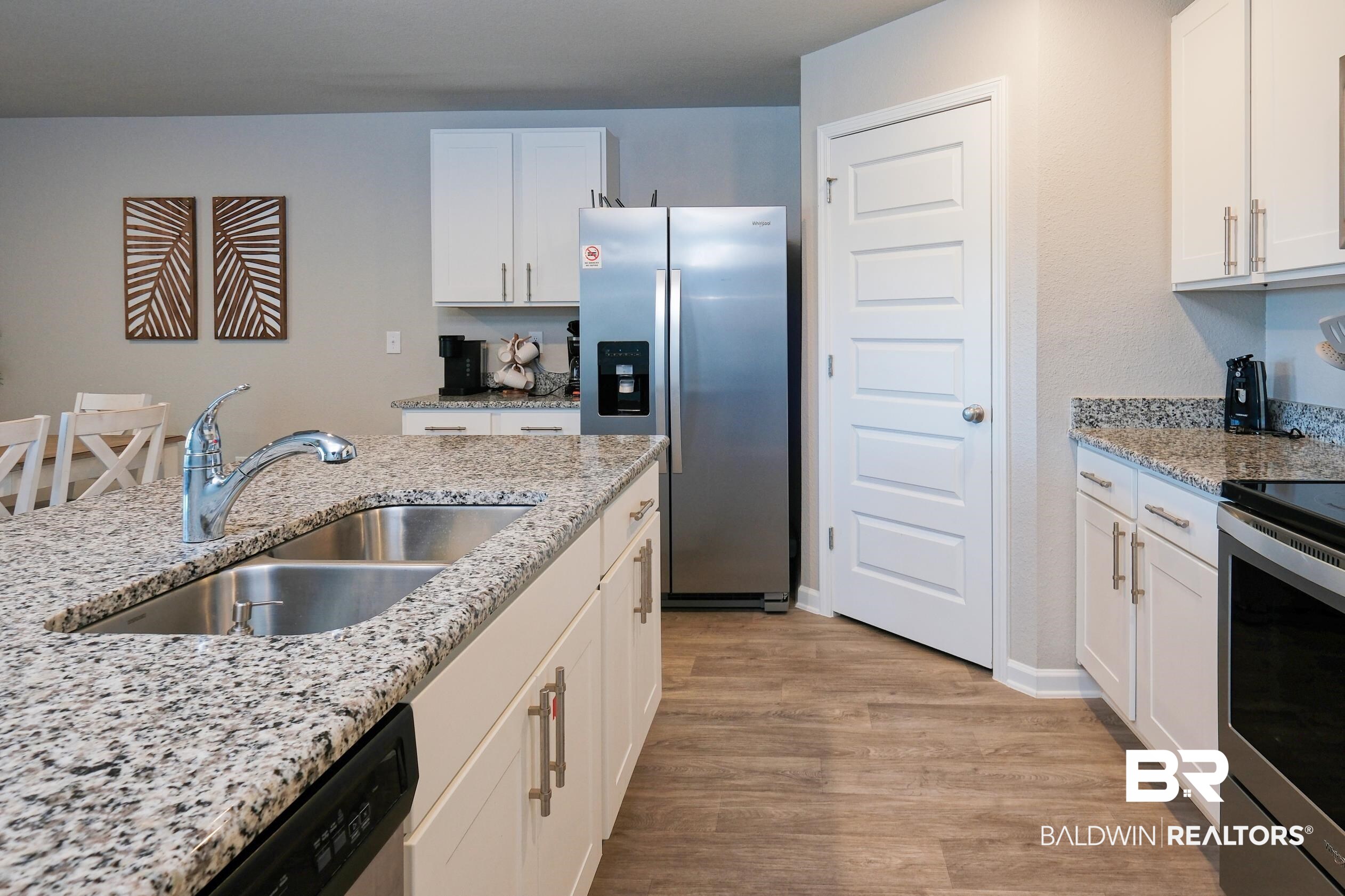 7425 Coppin Drive Foley, AL 36535 - Photo 7 of 41 Kitchen featuring light stone countertops, sink, light hardwood / wood-style flooring, and stainless steel appliances