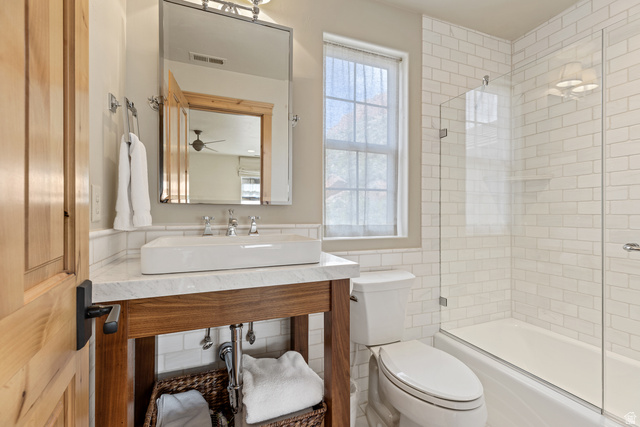 105 River Bend Circle, Unit 105 Springdale, UT 84767 - Photo 29 of 56 Bathroom featuring a wood-finish vanity with a rectangular vessel sink, a marble-finish countertop, and chrome fixtures