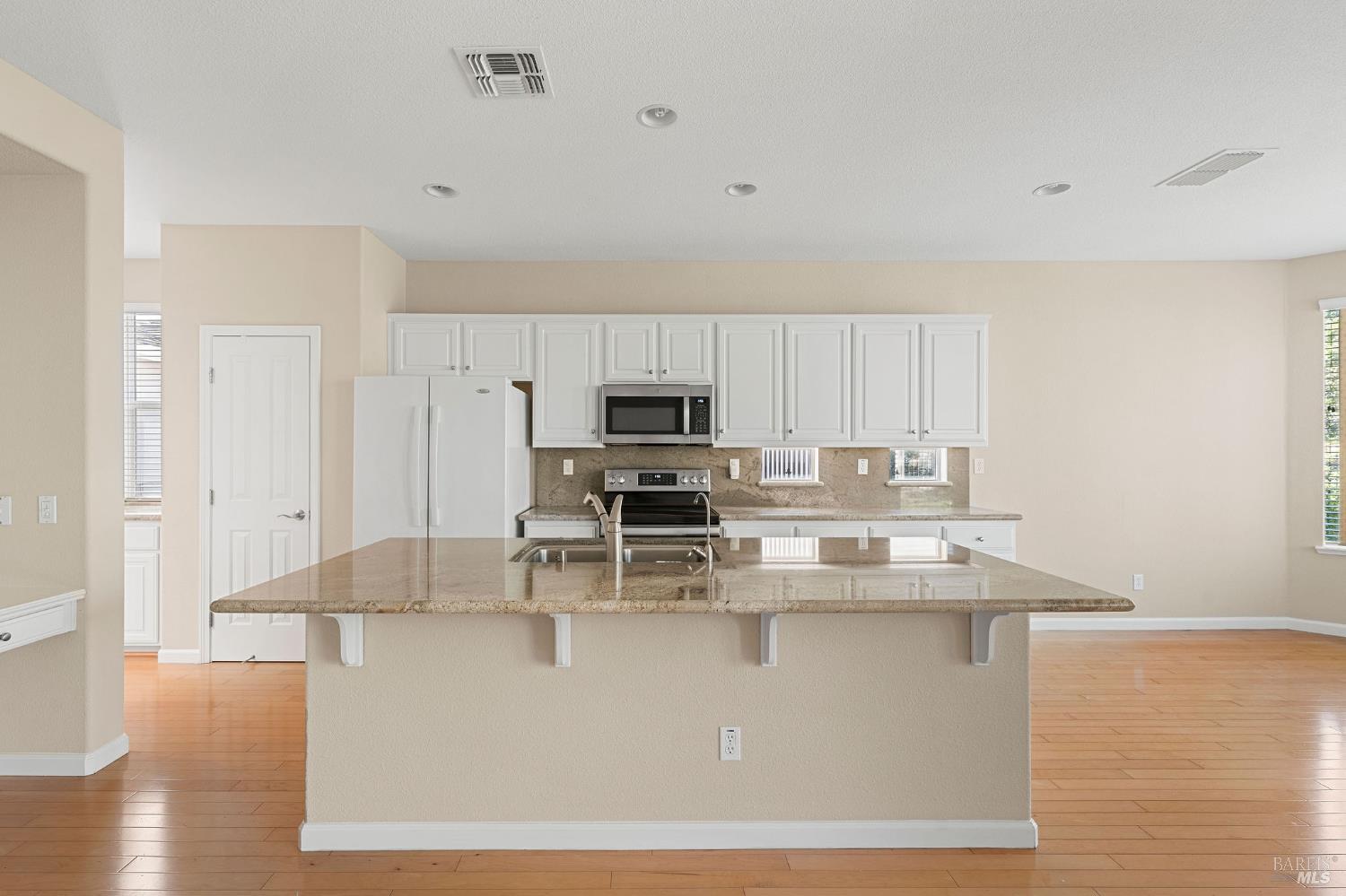 505 Marianna Place Rio Vista, CA 94571 - Photo 12 of 33 a view of kitchen with stainless steel appliances granite countertop a stove top oven a sink and dishwasher with wooden floor
