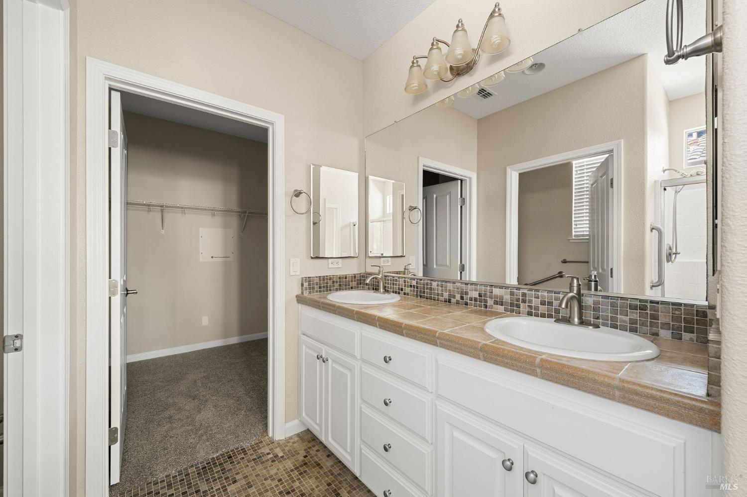 505 Marianna Place Rio Vista, CA 94571 - Photo 18 of 33 a spacious bathroom with a granite countertop sink and a mirror