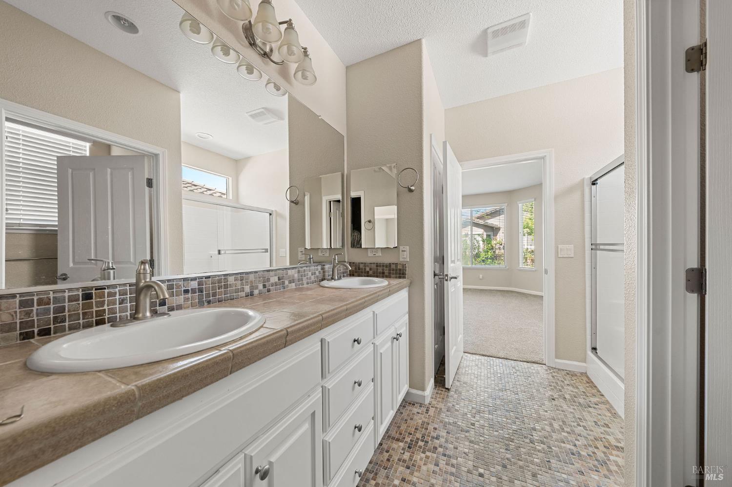 505 Marianna Place Rio Vista, CA 94571 - Photo 19 of 33 a spacious bathroom with a granite countertop sink and a mirror