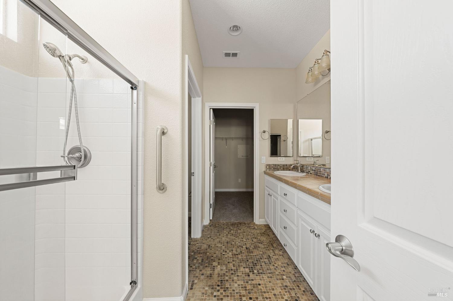 505 Marianna Place Rio Vista, CA 94571 - Photo 20 of 33 a bathroom with a granite countertop sink a mirror and a shower