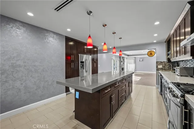 a kitchen with stainless steel appliances granite countertop a sink counter space and cabinets