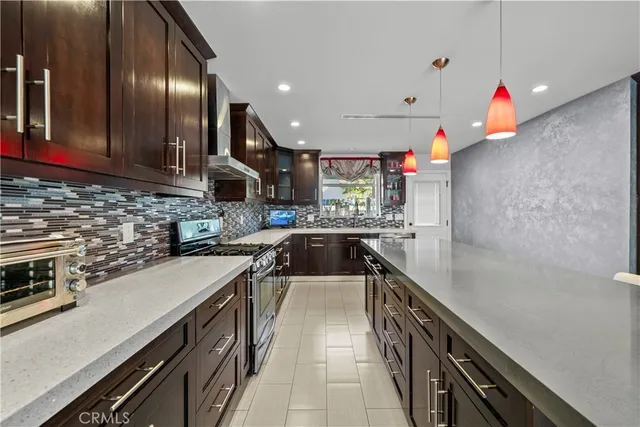 a kitchen with stainless steel appliances a sink stove and cabinets