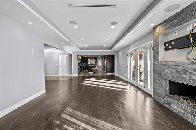 a view of dining room with wooden floor and fireplace