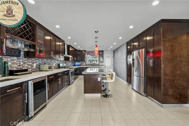 a kitchen with stainless steel appliances kitchen island granite countertop a sink cabinets and stainless steel appliances