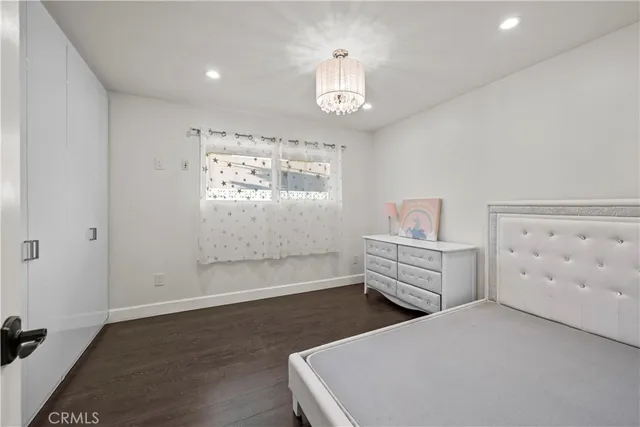 a bedroom with a bed and cabinets