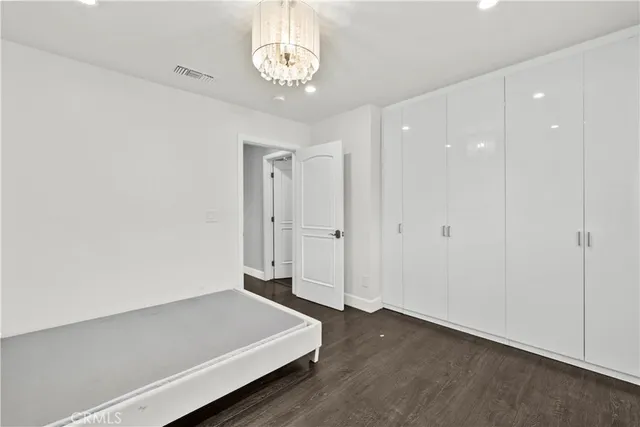 a view of a room with wooden floor and window