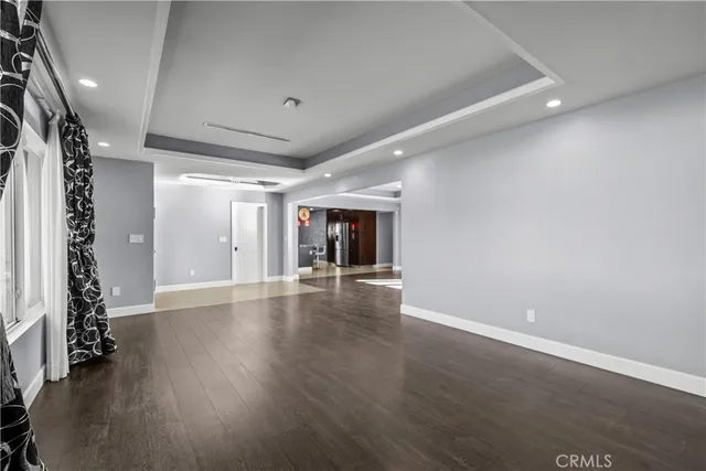 an empty room with wooden floor and window