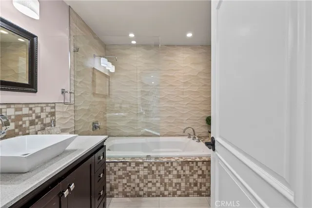 a bathroom with a bathtub and a sink