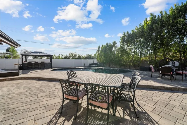 a view of a patio with dining table and chairs with wooden floor