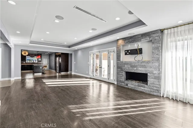 a view of an empty room with fireplace and a window